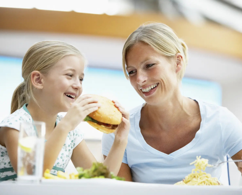 Little girl eating burger